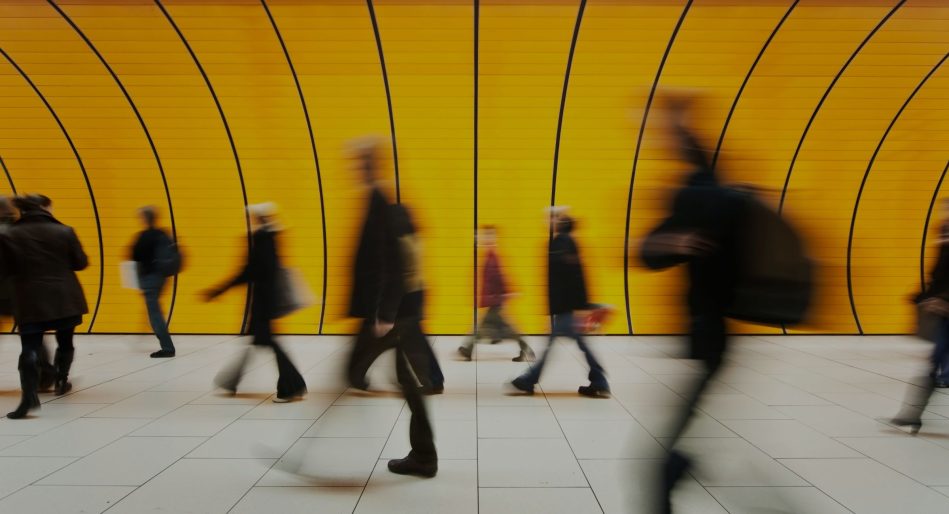 People walking in yellow tunnel
